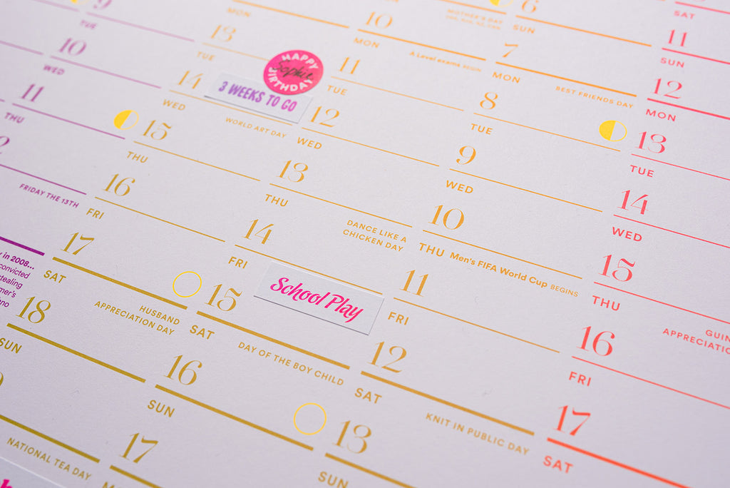 Close-up of a calendar with colorful text and dates. Luckyday Press Classic all Planner Ladyland press
