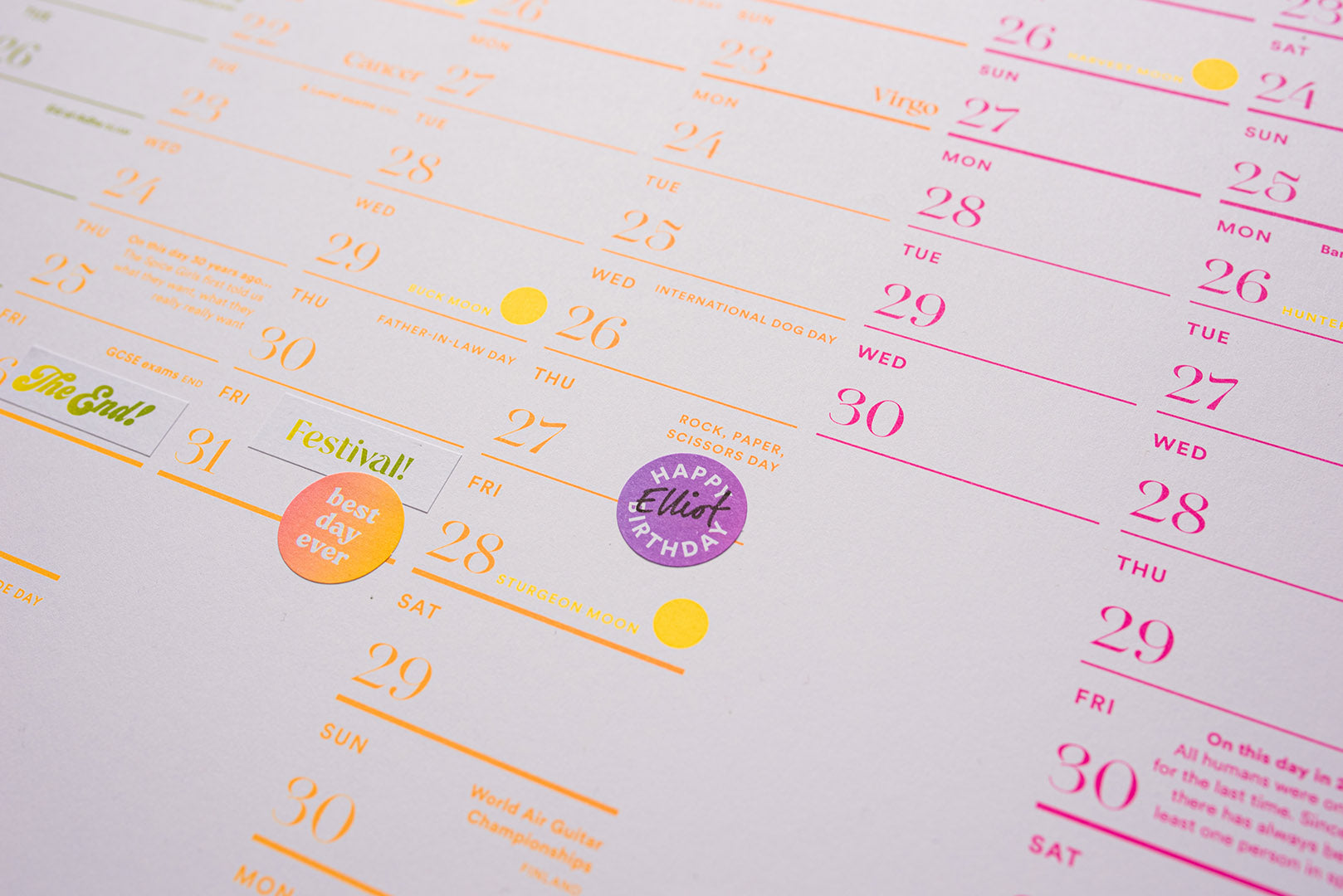 Calendar page with colorful stickers on a light gray background. Luckyday Press Classic all Planner Ladyland press
