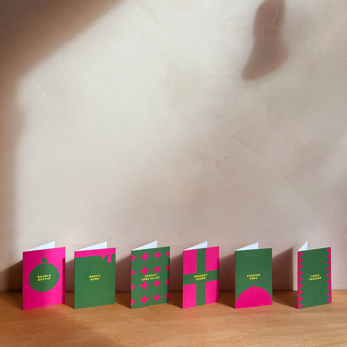 6 christmas cards lined up on a shelf