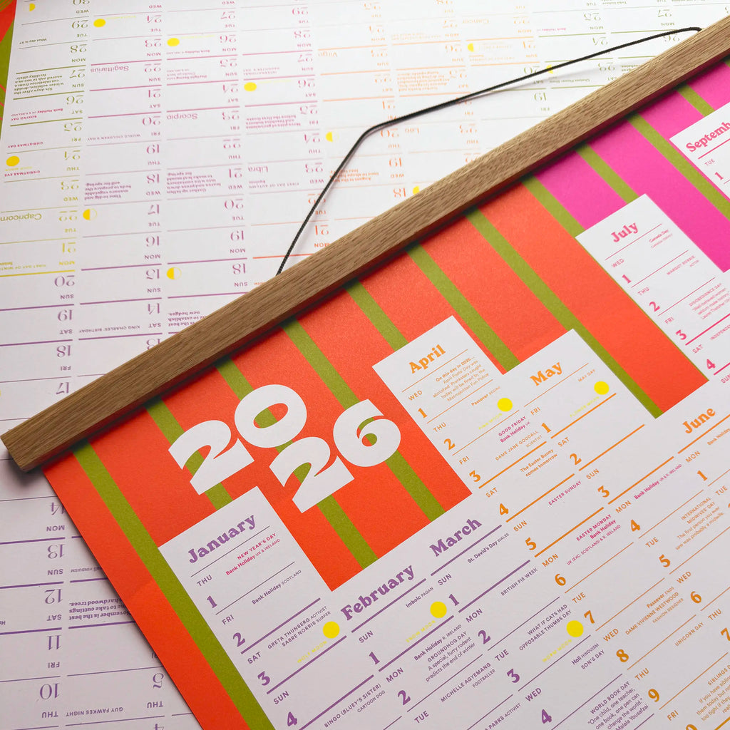 Colorful 2026 calendar with oak wooden magnetic frame on a white background